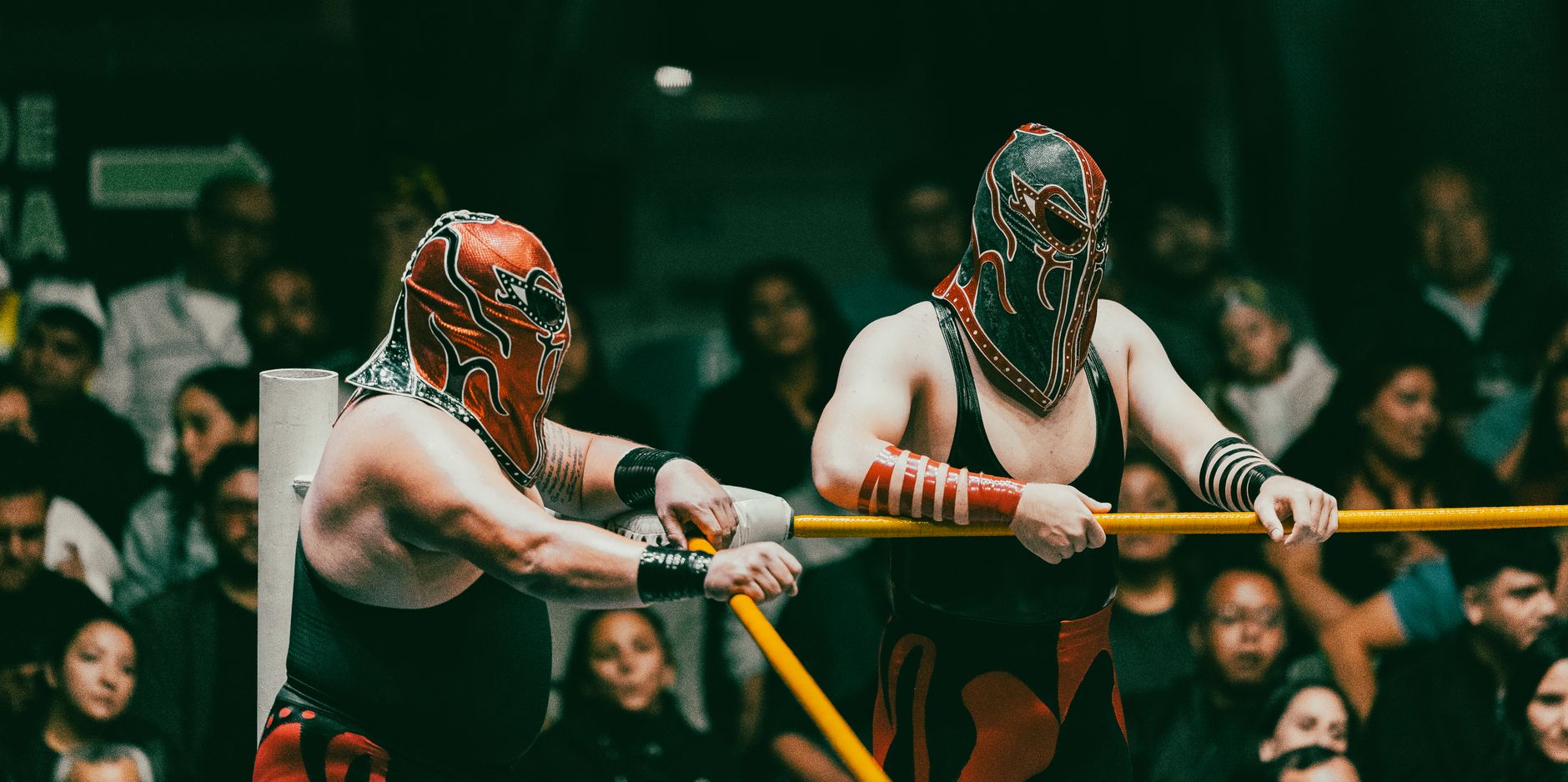 masked wrestlers in action at lucha libre event